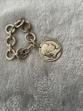 Silver tone coin bracelet.